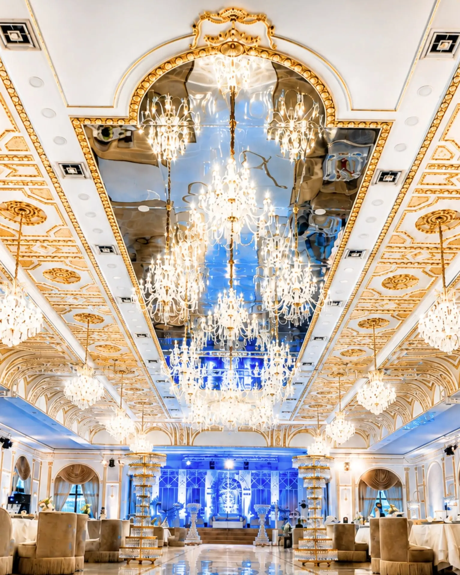 A cascade of crystal chandeliers under the gilded, mirrored ceiling of the Salle Royale